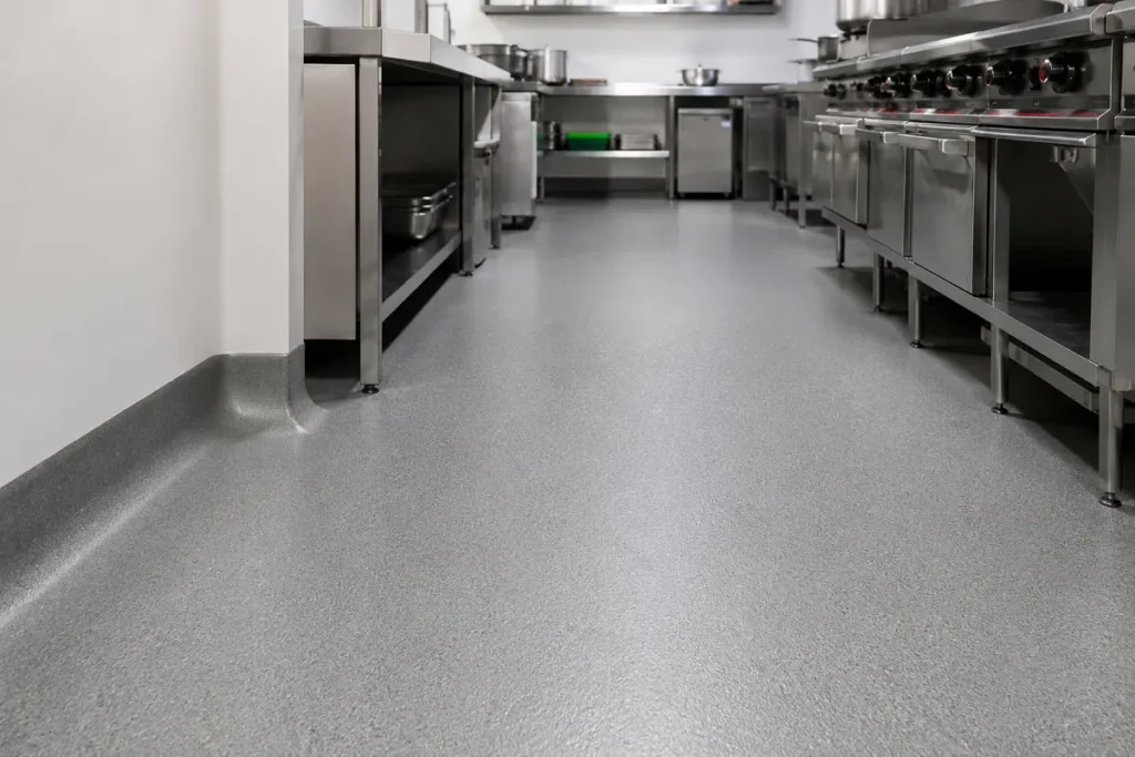 Commercial restaurant kitchen with slip-rated safety vinyl floor coved up the wall