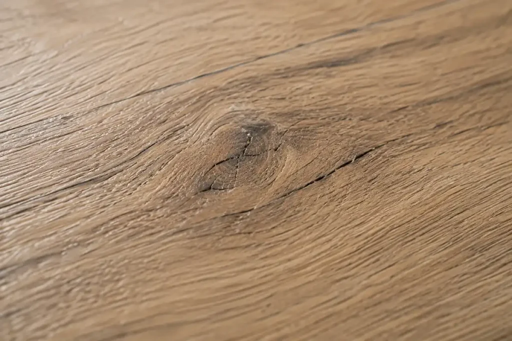 Close-up of realistic wood-look LVT vinyl flooring with natural grain and emboss