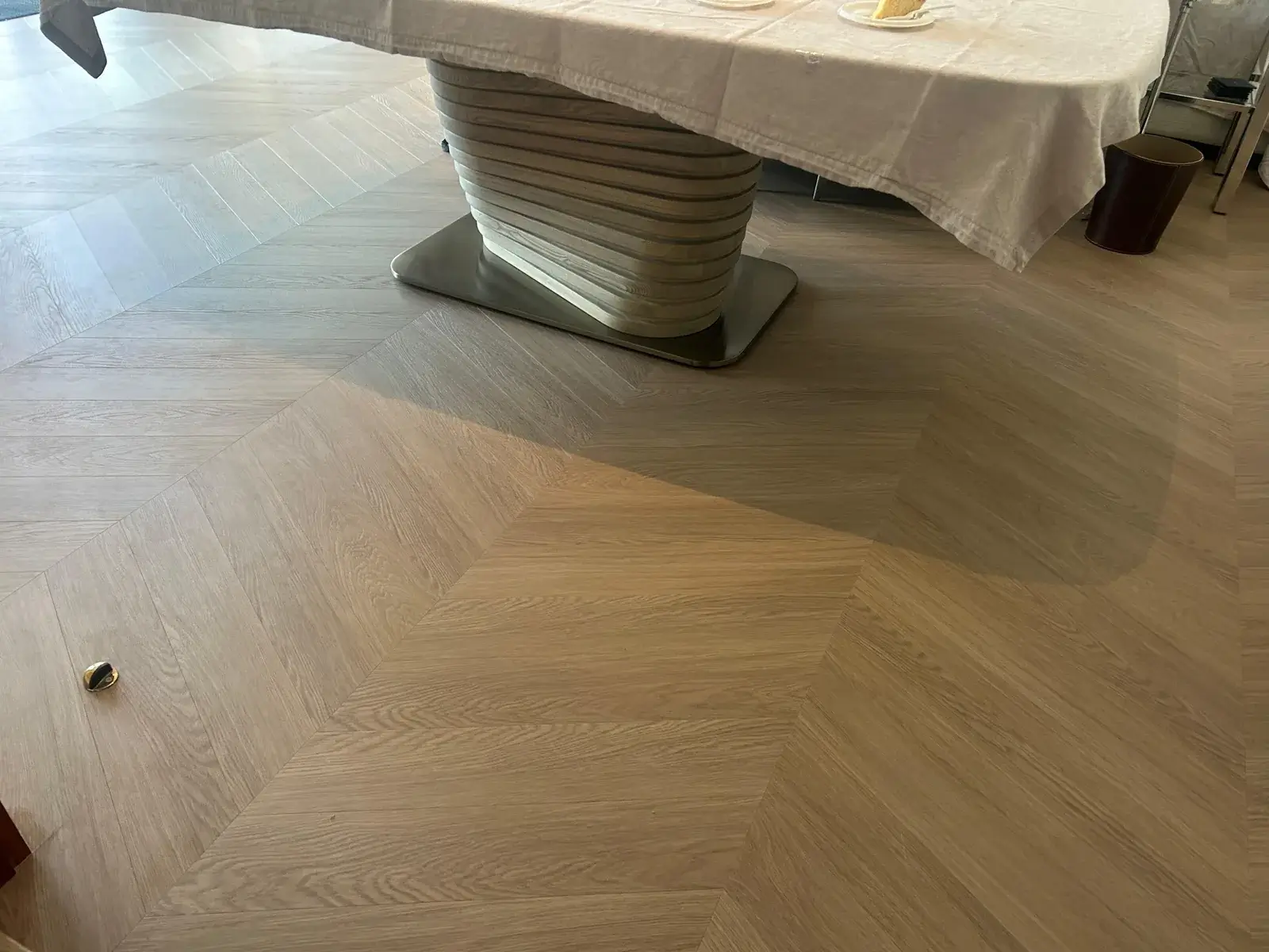 Close view of large-format chevron wood-look planks meeting in a V, Costa Brava Dubai