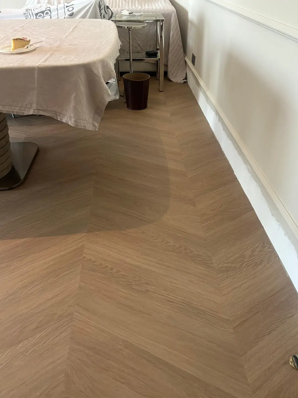 Chevron wood-look flooring cut along a wall line in a Costa Brava home, DAMAC Lagoons Dubai