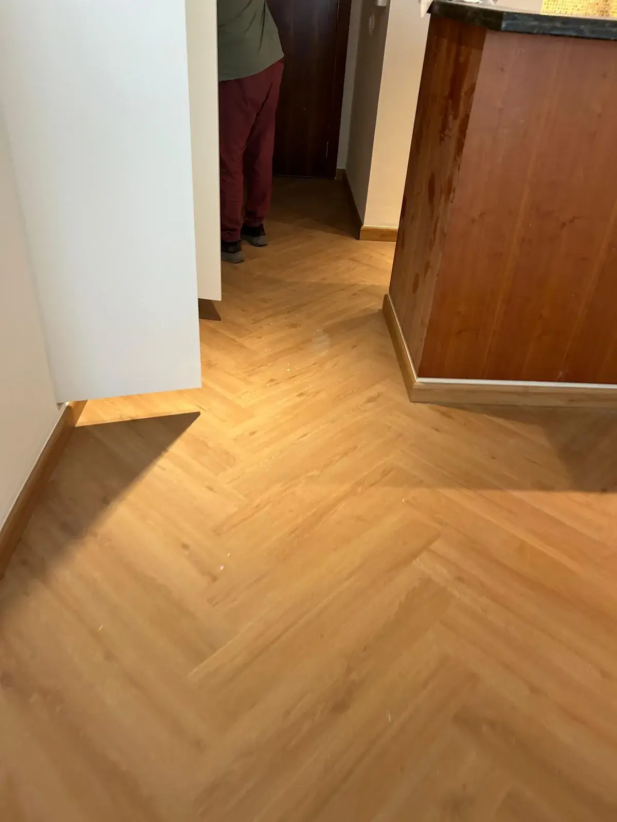 Herringbone SPC flooring at the kitchen entrance of a Valia Tower apartment, Dubai Creek Harbour