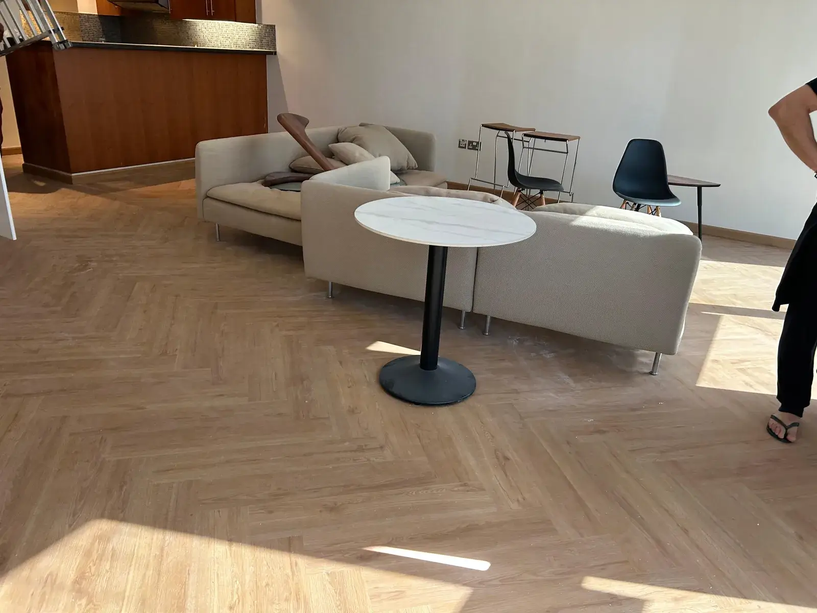 Herringbone SPC flooring across an open-plan living room in a Valia Tower duplex, Dubai Creek Harbour