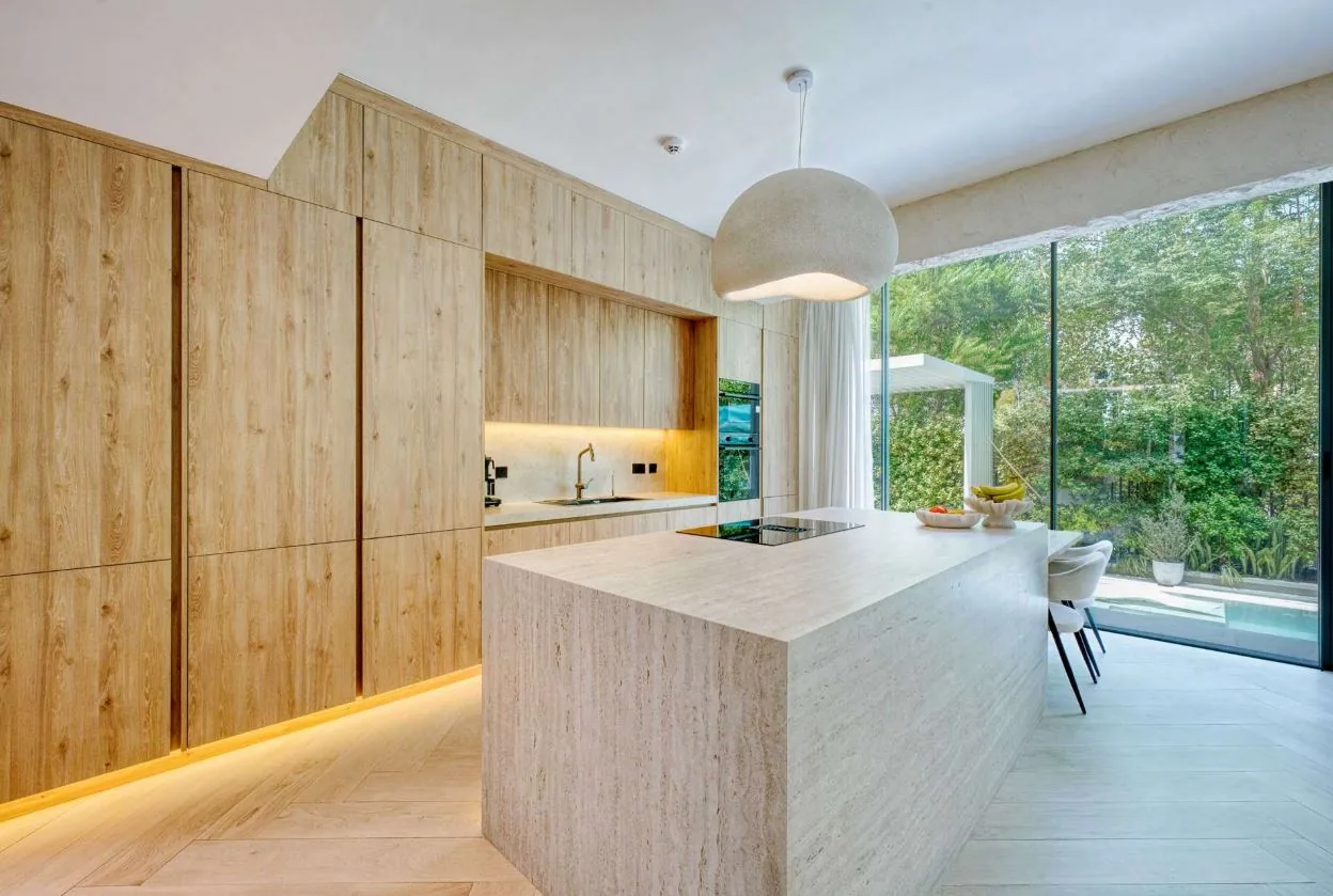 Chevron wood-look SPC flooring in an open-plan villa kitchen, Tilal Al Ghaf Dubai