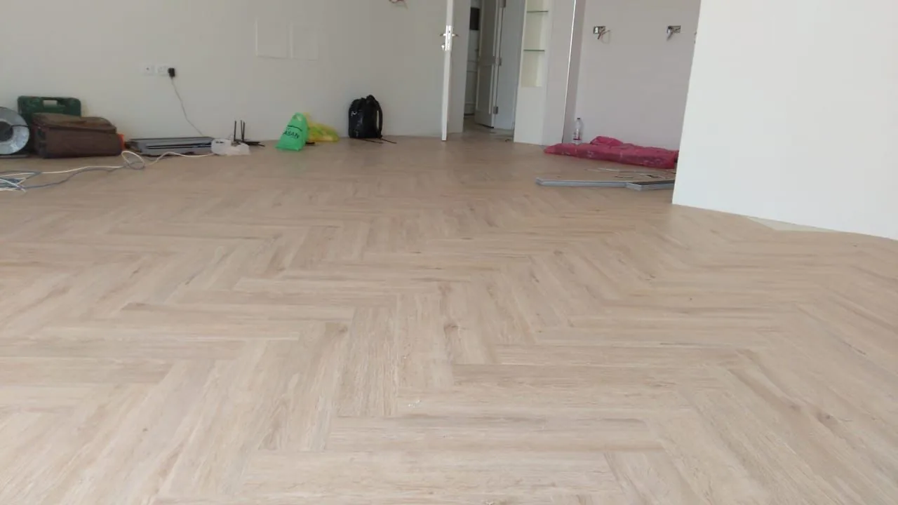 Herringbone SPC flooring installation in an Al Mamzar apartment, Dubai