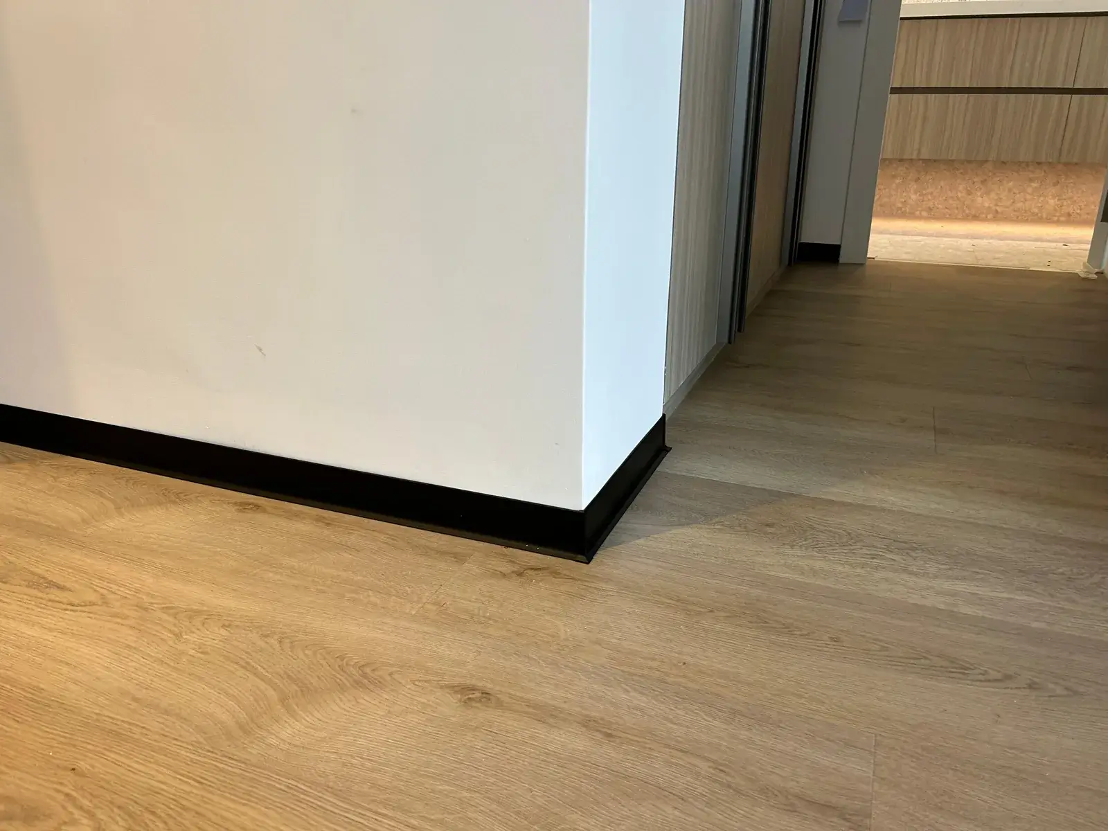 SPC flooring running along a corridor toward the kitchen, Al Nahda 2 apartment Dubai