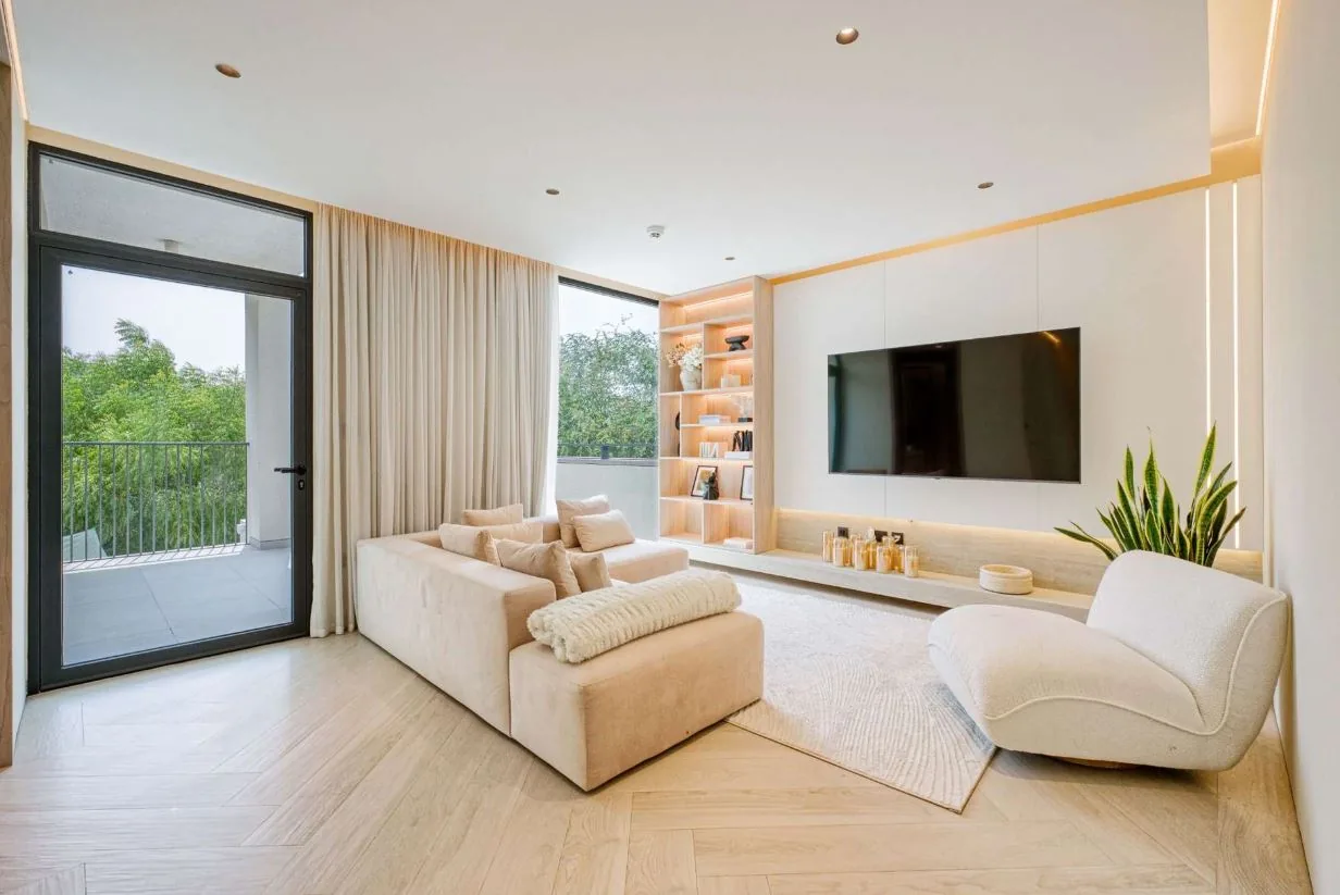 Chevron wood-look SPC flooring and a textured rug in a villa TV lounge, Tilal Al Ghaf Dubai