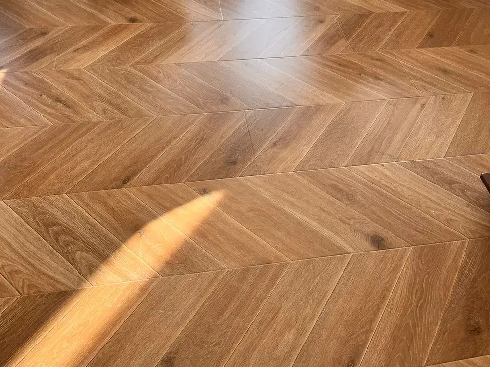 Close view of chevron engineered wood boards showing the mitred joints and the continuous V pattern