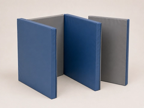 Hinged folding panel gymnastics mat, partly folded to show the panels