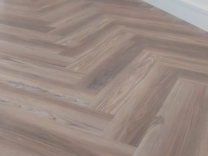 Darker walnut herringbone engineered wood flooring in a bedroom at Cloud 9, Al Sufouh