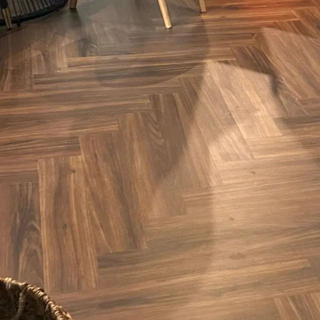 Herringbone LVT flooring in an apartment dining area at Land Residence Complex, Dubai