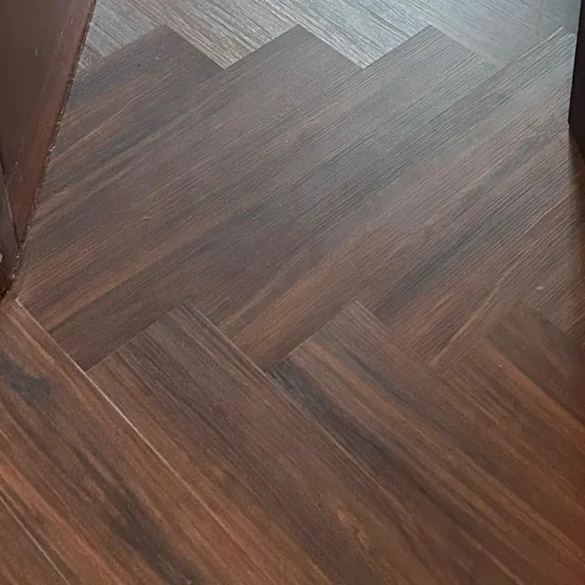 Herringbone LVT flooring carrying through a doorway without a threshold strip, Land Residence Complex, Dubai