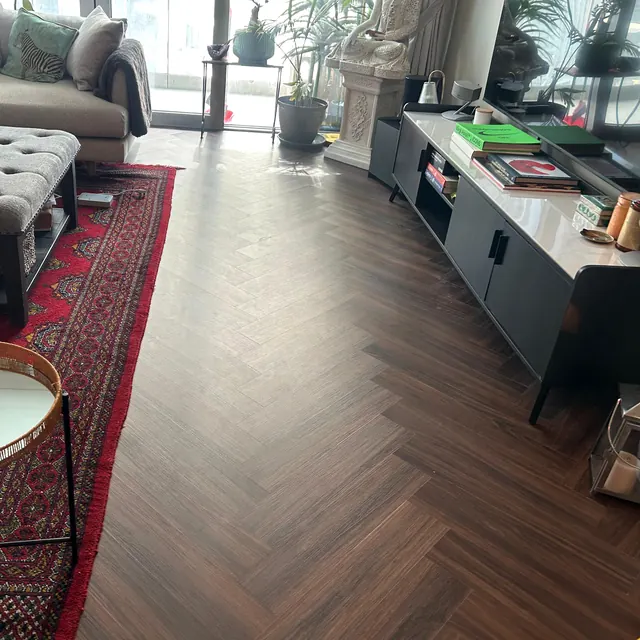 Herringbone LVT flooring in an apartment living room with window light, Land Residence Complex, Dubai