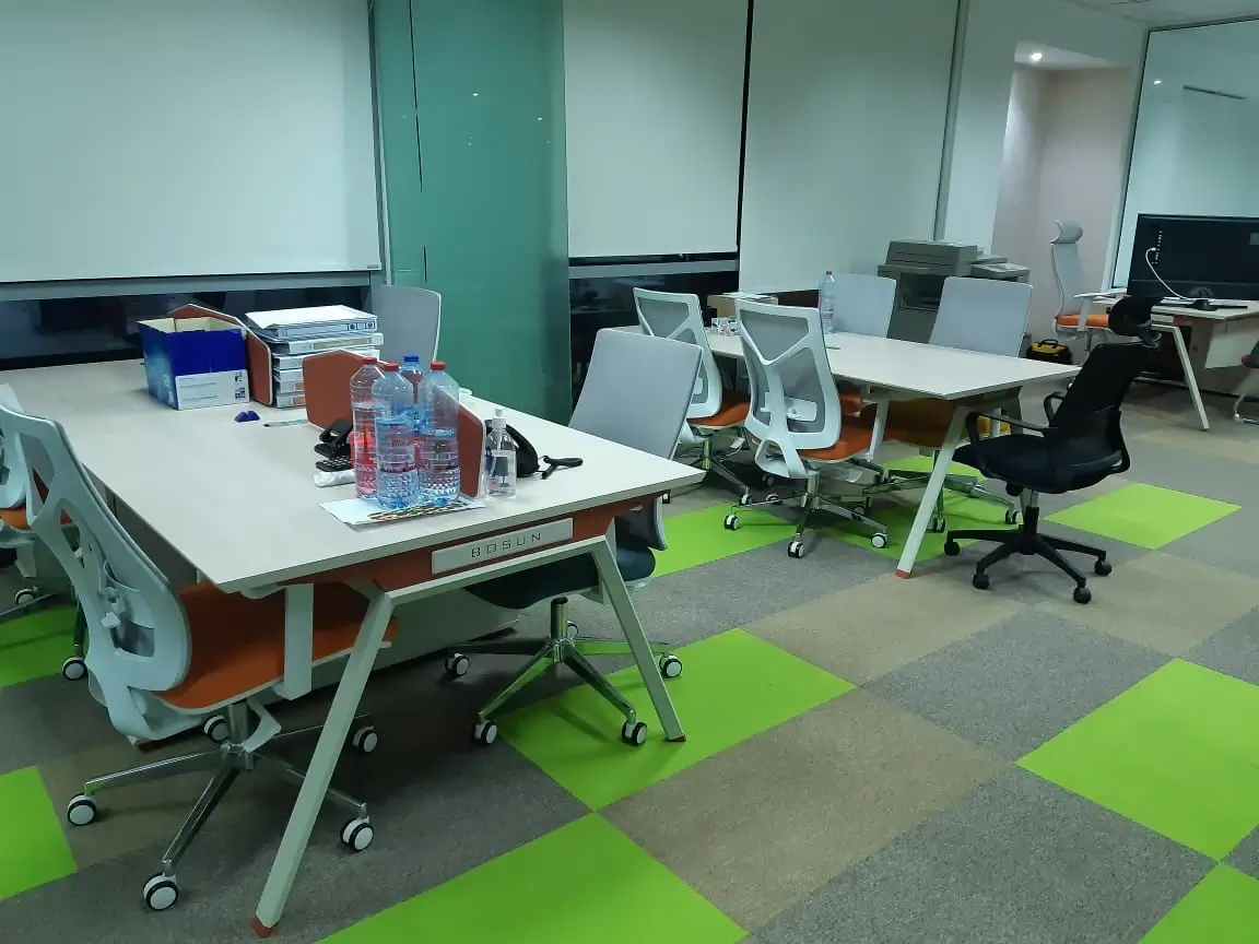 Lime green, grey and beige carpet tiles across an open-plan office floor in Jumeirah Lakes Towers, Dubai