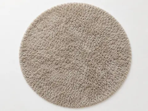 Shaggy high-pile round area rug in a soft neutral tone