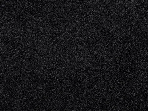 Deep black area rug with a subtle sheen