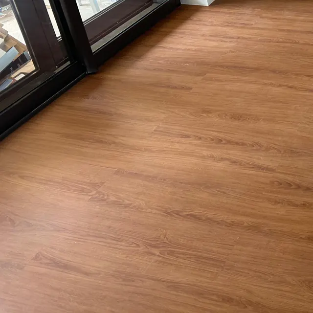 WPC plank flooring meeting the track of a balcony sliding door in a JVT apartment