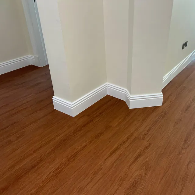 WPC plank flooring carried around a projecting wall return with the skirting following the angle, JVT apartment