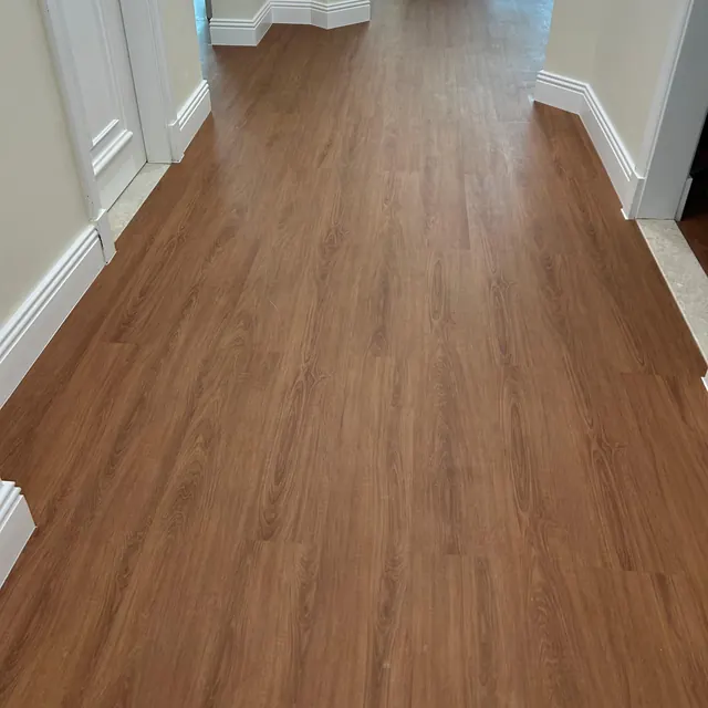 WPC plank flooring running the length of an apartment hallway past a wall return, Enaya Residences JVT